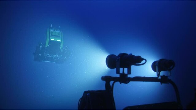 Lights Shine On Underwater Submarine