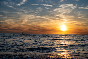 Italian sunset on the beach in landscape, Capri and Ischia in background