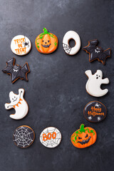 Halloween greeting card with copy space. Set of Halloween gingerbread cookies on dark stone background - 649007925