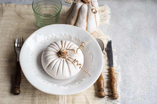 Autumnal table setting with pumpkin