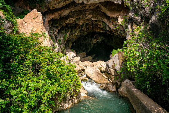 Crystal clear water washing on rough rocky cave