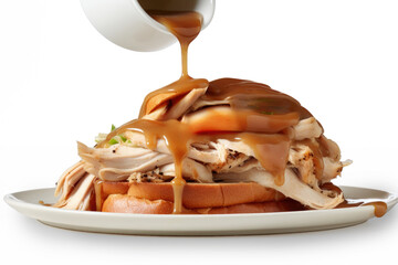 Gravy Being Poured over a Hot Turkey Sandwich Isolated on a White Background