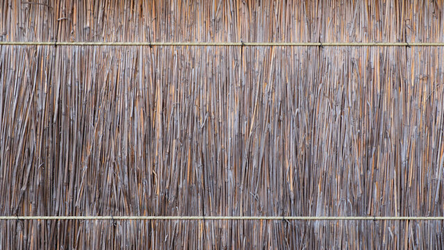 Texture of dry reeds, fence or roof made of reeds.