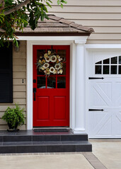 bright red front door to a old fashioned farmhouse cottage