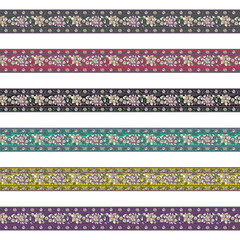 A set of four different colored floral borders