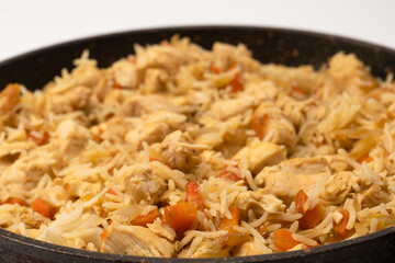 Tasty pilaf with chicken as background.