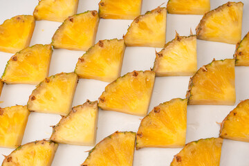 Pineapple juicy yellow slices on a white background.