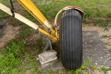yellow landing gear of an old propeller engine with rubber tires