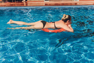 Portrait beautiful young asian women happy smile relax outdoor swimming pool in resort hotel for vacation travel.