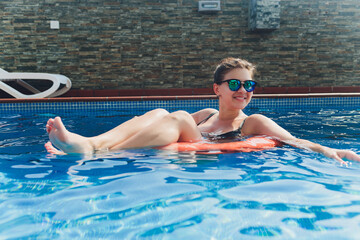 Portrait beautiful young asian women happy smile relax outdoor swimming pool in resort hotel for vacation travel.