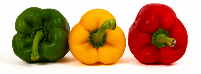 3 Bell peppers, of 3 colors: Green, red and yelow, close up isolated on white background