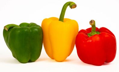 3 Bell peppers, of 3 colors: Green, red and yelow, close up isolated on white background
