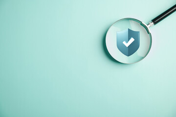 Cybersecurity and privacy concepts safeguarding data. Magnifying glass zooms in on shield lock icon. Internet network security technology. Protecting personal data with virtual screen interfaces.