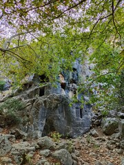 Pinara ruins of an ancient city near Fethiye, Mugla, Türkiye. Lycian tombs, ancient Roman amphitheater and mountains.