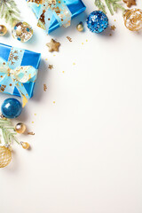 Christmas vertical banner with blue and gold baubles, gift boxes, star ornaments and confetti...