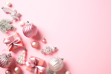 Elegant Christmas decorations on pastel pink background. Flat lay, top view, copy space.