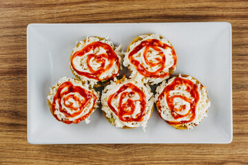Venezuelan tostones with sauces and grated white cheese