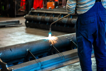 Heating up of metal construction with acetylene and oxygen burner in process of flame straightening with visible red colour of heated metal