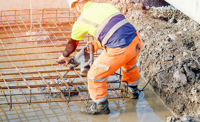 Builder using electric braker fot breaking concrete from the top of pile to fit reinforcement cage...