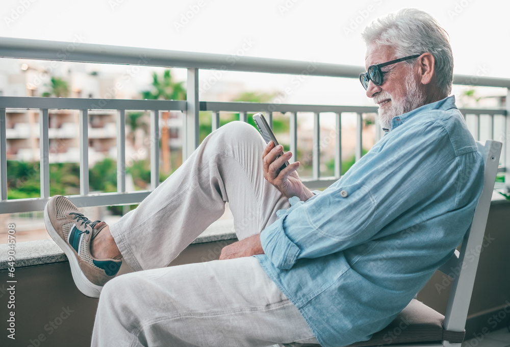 Canvas Prints Video call concept. Handsome smiling bearded senior man talking on mobile phone using phone webcam to communicate in video chat