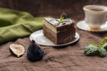 chocolate cake on white plate and tea with strawberry