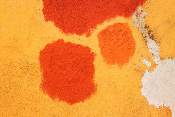 Texture of old house concrete wall painted into deep Vibrant warm golden yellow color with orange...