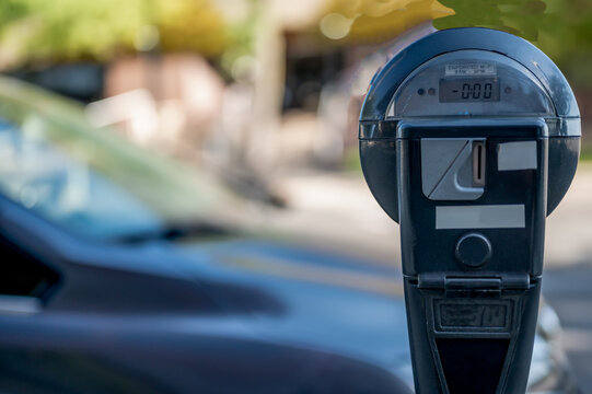 Selective focus on an expired parking meter with no time left.
