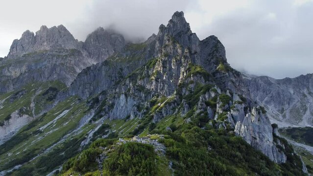 Aerial 4k drone footage of stunning mountain range near Dachstein massif. Amazing steep peaks covered by green grass. Beautiful Mountain panorama like from Avatar movie. Filzmoos, Austria, Europe