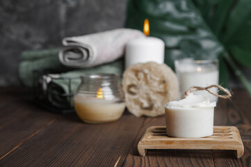 Natural soap, loofah scrubber on podium in bathroom. Zero waste in life. Relaxation spa concept, candles, beauty...