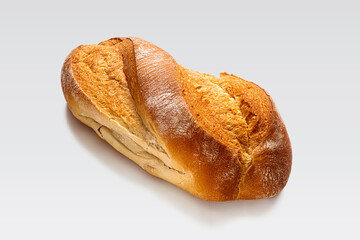 Homemade white bread with a golden crust on a light background