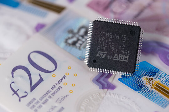 ARM ST32 chip placed on 20 pounds banknote. Concept. Selective focus. London, United Kingdom, September 17, 2023