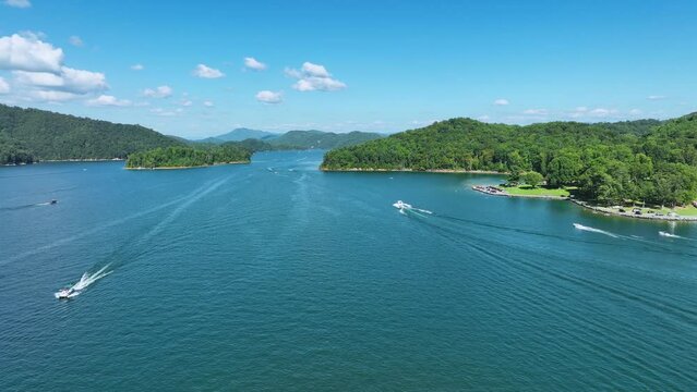 Drone footage of boats and sailboats with mountains in the background,  on beautiful Watauga Lake in eastern, Tn.