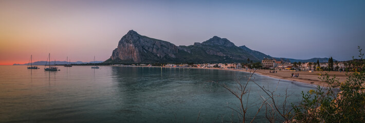Sunrise on the paradise Tyrrhenian sea bay. San Vito lo Capo and Monte Monaco in far, Sicily, Italy. June 2023, Panoramic picture