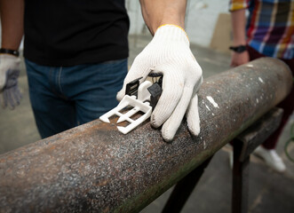 The teacher conducts a master class on fixing pressure leaks in a pipeline using a repair clamp.
