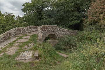 Fototapeta na wymiar Approach to an ancient packhorse bridge
