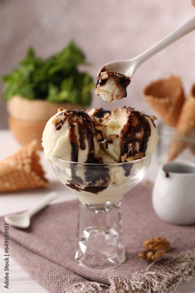 Canvas Prints Eating tasty ice cream with chocolate topping and nuts at table