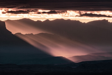 Pink Rays of Sun Shine Through Fog and Clouds Below the Sierra Del Carmen