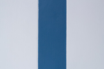 Textured of blue cement wall and dark blue making a groove for a pole for background.