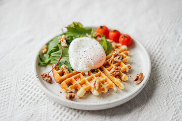 Breakfast waffles poached eggs and salad