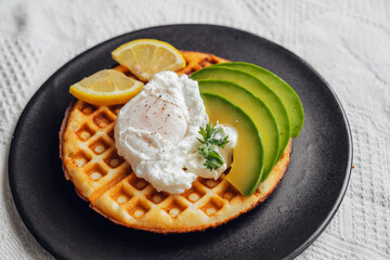 Waffles poached eggs with avocado and cream