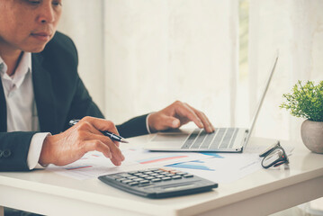 Close up man hands Asian businessman  calculating number, audit planning on business report Asian...