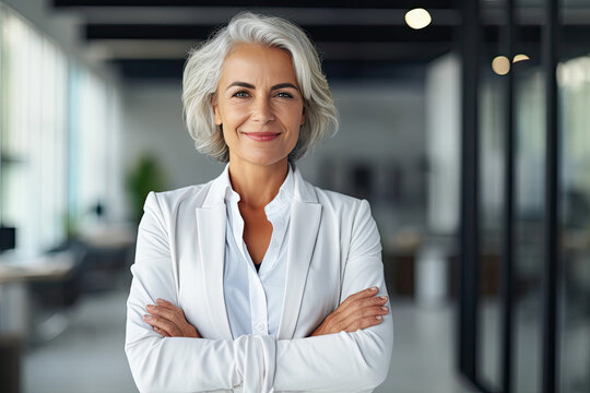 Casual portrait of a designer in her office standing by her desk, daylight coming through the window, corporate photography, Asian woman