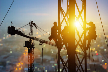 Silhouette of Engineer and worker working crane on steel structures industrial project at building...