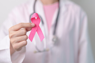 Pink October Breast Cancer Awareness month, doctor with pink Ribbon in hospital for support people...