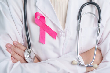 Pink October Breast Cancer Awareness month, doctor with pink Ribbon in hospital for support people life and illness. National cancer survivors month, Mother and World cancer day concept