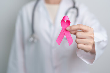 Pink October Breast Cancer Awareness month, doctor with pink Ribbon in hospital for support people...