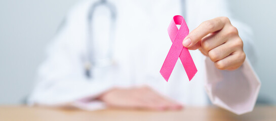 Pink October Breast Cancer Awareness month, woman doctor with pink Ribbon in hospital for support...