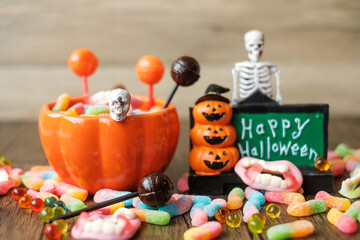 Obraz premium Happy Halloween day with ghost candies, pumpkin bowl, Jack O lantern and decorative (selective focus). Trick or Threat, Hello October, fall autumn, Festive, party and holiday concept