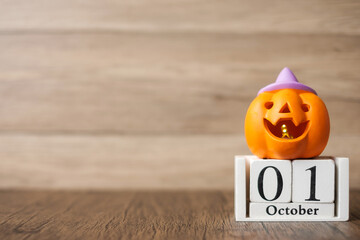 Happy Halloween day with Jack O lantern pumpkin and 1 October calendar. Trick or Threat, Hello October, fall autumn, Festive, party and holiday concept - obrazy, fototapety, plakaty