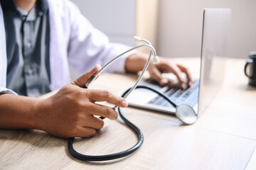 Close up doctor during tele medicine using laptop 